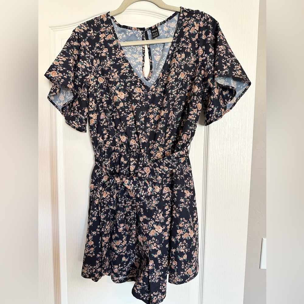 SHEIN navy blue romper with floral pattern.